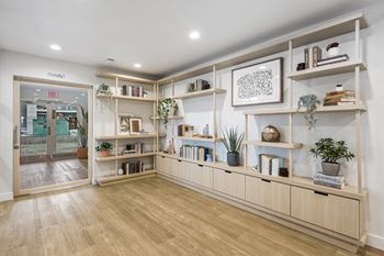 a living room with wooden shelves and a door  at Citrine Hills, Ontario, CA